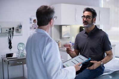 Man having conversation with his doctor in the clinic 