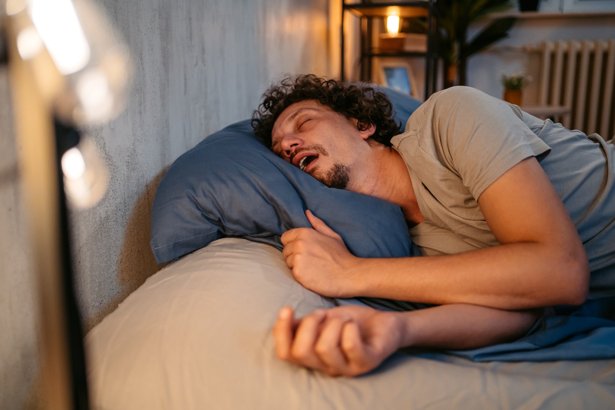 Man snoring in bed