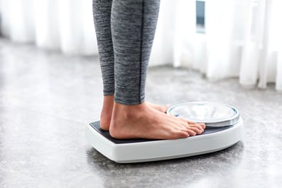 Woman stands on a scale
